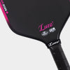 Close-up detail of the LUZZ Glider 2026 Hybrid Paddle face featuring a pink LUZZ logo and white UPA-A and USAP certification logos at the bottom