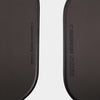 Close-up detail of a black pickleball paddle face featuring “CARBON FIBER T700” on one side and “CANNON 2 M1” on the other